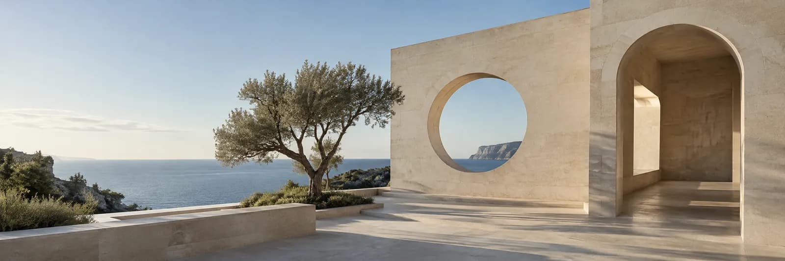 A sunlit limestone arch framing an open horizon over the sea